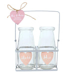 His and Hers  glass milk bottles in a wire display rack